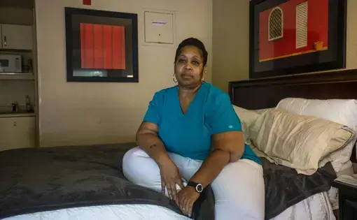 Catrice Otengo sits for a portrait on July 31 in the Greensboro hotel room she is renting following an eviction during the coronavirus pandemic. Image by Casey Toth / The News & Observer. United States, 2020.